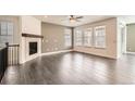 Bright living room featuring hardwood floors, a cozy fireplace, and plenty of natural light at 14952 Vienna Cir, Parker, CO 80134