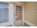 Gray front door with glass panels and a storm door at 15800 E 121St Ave # 3J, Brighton, CO 80603