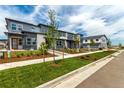 Street view of modern townhomes with well-maintained landscaping, sidewalks, and inviting entryways at 5785 N Jericho Way, Aurora, CO 80019