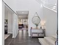 Bright entryway with hardwood floors, high ceilings, modern staircase, and decorative mirror at 11025 Watermark St, Parker, CO 80134