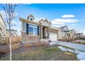 Landscaped front yard and stone accents highlight this charming home with a two-car garage at 26310 E 3Rd Pl, Aurora, CO 80018