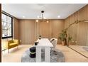 Bright home office featuring wood paneling, statement mirror, and modern light fixture at 1823 W 35Th Ave, Denver, CO 80211