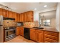 Cozy kitchen has stainless steel appliances, wooden cabinets, and lovely countertops at 800 N Pearl St # 702, Denver, CO 80203