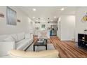 Open-concept living space with hardwood floors, a modern kitchen, and stylish furnishings at 871 S Worchester St, Aurora, CO 80012