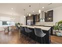 Modern kitchen with dark cabinetry, a large island, and stainless steel appliances at 1336 Sheridan Blvd # 108, Denver, CO 80214