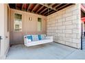 Cozy porch with a relaxing swing, perfect for enjoying outdoor moments at 9180 E 52Nd Dr, Denver, CO 80238
