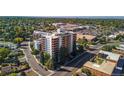 A high angle view shows the high rise condo with its brick and white exterior at 4570 E Yale Ave # 1004, Denver, CO 80222