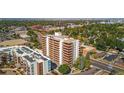 A wide aerial view of the condo with its solar panels and brick design at 4570 E Yale Ave # 1004, Denver, CO 80222