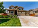 Charming two-story home with a welcoming front porch and a well-manicured lawn at 16321 Clayton St, Thornton, CO 80602