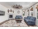 Cozy living room with a fireplace, stylish decor, and comfortable seating at 16321 Clayton St, Thornton, CO 80602