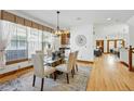 Elegant dining room with hardwood floors and a modern chandelier over the glass table at 2424 S Steele St, Denver, CO 80210