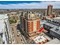 Stunning aerial view of building with a large patio, showcasing its location and surrounding cityscape at 1950 N Logan St # 411, Denver, CO 80203