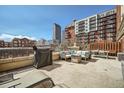 Spacious patio area offering city views, comfortable seating, and a grill, ideal for entertaining at 1950 N Logan St # 411, Denver, CO 80203