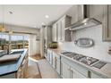 Modern kitchen featuring stainless steel appliances, light gray cabinets, granite countertops, and a gas cooktop at 8872 E 47Th Ave, Denver, CO 80238