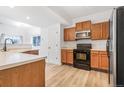 Well-equipped kitchen with stainless steel appliances and wood cabinets, perfect for cooking at 9032 Gale Blvd # 1, Thornton, CO 80260