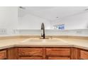 Kitchen sink with bronze faucet and cream cabinets, offering a clean and functional space at 9032 Gale Blvd # 1, Thornton, CO 80260