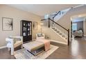 Bright living area with modern furnishings, a decorative rug, and staircase with contemporary design at 4545 S Monaco St # 436, Denver, CO 80237