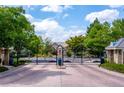 Gated entrance to the community with lush greenery and manicured landscaping at 4545 S Monaco St, Denver, CO 80237