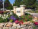 Stone monument with address number and floral arrangement at community entrance at 4545 S Monaco St, Denver, CO 80237