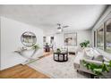 Bright living room with hardwood floors, contemporary furnishings, and lots of natural light at 7350 Dale Ct, Westminster, CO 80030