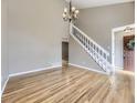 Spacious living room with hardwood floors, staircase, chandelier, and a neutral color scheme at 4267 Ashcroft Ave, Castle Rock, CO 80104