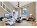Bright living room boasts vaulted ceilings, staircase, and a large window at 4267 Ashcroft Ave, Castle Rock, CO 80104