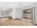 Bright living room featuring new floors, sliding glass doors and modern lighting at 1336 Sable Blvd, Aurora, CO 80011