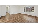 Spacious living room featuring wood floors, bright natural light, and a modern aesthetic at 1336 Sable Blvd, Aurora, CO 80011
