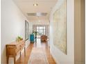 Bright hallway with hardwood floors, contemporary art, and stylish furniture at 1590 Little Raven St # 702, Denver, CO 80202