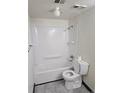 Full bath features a shower and tub with a toilet and tiled floors at 7665 E Eastman Ave # 104A, Denver, CO 80231