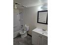A full bathroom featuring a shower/tub combo, toilet, tile flooring, and single sink vanity with a mirror at 7665 E Eastman Ave # 104A, Denver, CO 80231