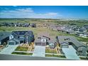 Stunning aerial view of a suburban neighborhood, displaying single-Gathering homes with generous lot sizes and open spaces at 14337 Shasta Daisy Pt, Parker, CO 80134