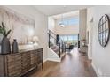 Inviting foyer with high ceilings, hardwood floors, and a staircase leading to the upper level at 14337 Shasta Daisy Pt, Parker, CO 80134