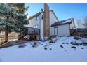 Home's back deck and backyard with snow covering the ground at 3080 E Geddes Pl, Centennial, CO 80122