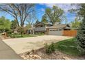 Well-maintained two-story home with a spacious driveway and manicured front lawn at 11305 W 78Th Dr, Arvada, CO 80005
