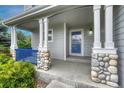 Welcoming front porch featuring stone-covered posts and a blue railing, adding character to the home's entrance at 2171 E 99Th Pl, Thornton, CO 80229