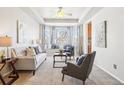 Bright living room with bay window, comfy seating, and hardwood floors at 5008 S Nepal St, Centennial, CO 80015