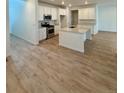 Bright kitchen with white cabinets, stainless steel appliances, and an island with sink at 9041 Redfield Ln, Parker, CO 80134
