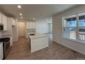 Spacious kitchen with stainless appliances, a center island, and hardwood floors at 9041 Redfield Ln, Parker, CO 80134