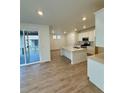 Modern open kitchen featuring an island, stainless steel appliances, and access to a deck at 9041 Redfield Ln, Parker, CO 80134