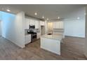 Bright kitchen with modern stainless steel appliances and a large center island at 9041 Redfield Ln, Parker, CO 80134