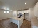 Open kitchen featuring white cabinets, stainless steel appliances, and center island at 9041 Redfield Ln, Parker, CO 80134