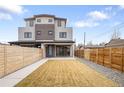 Exterior showcasing fenced backyard with lawn, a modern facade, and stylish gray and brick accents at 1953 W 47Th Ave, Denver, CO 80211