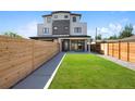 A modern home with a spacious fenced backyard and lush green grass at 1953 W 47Th Ave, Denver, CO 80211
