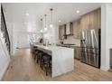 Bright kitchen features a large island with seating, stainless steel appliances, and modern cabinets at 1953 W 47Th Ave, Denver, CO 80211