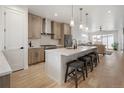 Open kitchen design with an island, stainless steel appliances, modern cabinets, and pendant lighting at 1953 W 47Th Ave, Denver, CO 80211