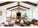Bright living room featuring hardwood floors, exposed beams and a comfortable seating arrangement at 6389 S Monaco Ct, Centennial, CO 80111