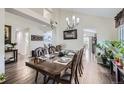 Elegant dining room with a large table, chandelier, and access to other rooms at 4205 E 106Th Pl, Thornton, CO 80233