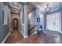 Inviting foyer with hardwood floors, coffered ceilings, elegant chandelier, and a seamless transition to other living areas at 8463 S Quemoy Ct, Aurora, CO 80016