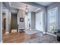 Elegant foyer with hardwood floors, coffered ceilings, and seamless transition to the staircase and other living spaces at 8463 S Quemoy Ct, Aurora, CO 80016